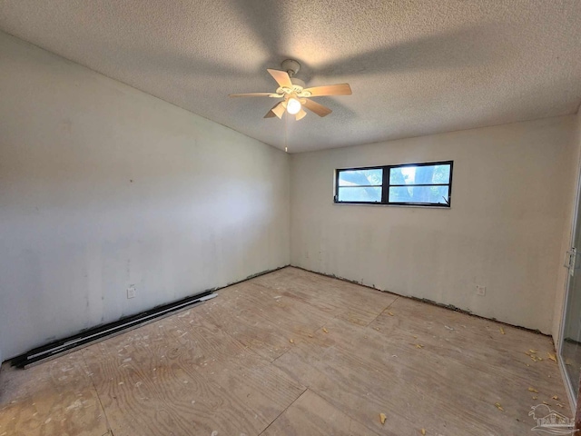 unfurnished room featuring ceiling fan and a textured ceiling