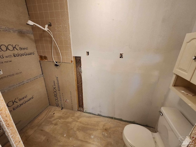 bathroom with concrete floors and toilet