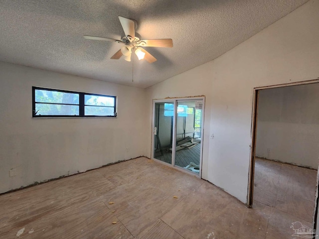 unfurnished bedroom with ceiling fan, vaulted ceiling, a textured ceiling, and access to outside