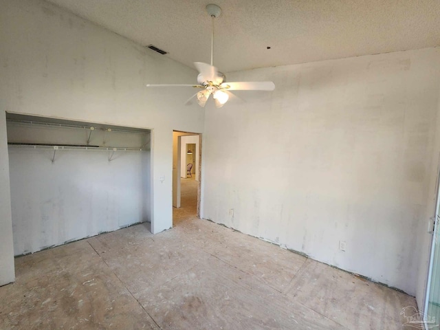 unfurnished bedroom with a textured ceiling, ceiling fan, a closet, and visible vents