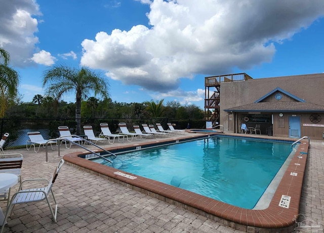 view of swimming pool with a patio