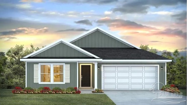 view of front of house featuring a garage and a lawn