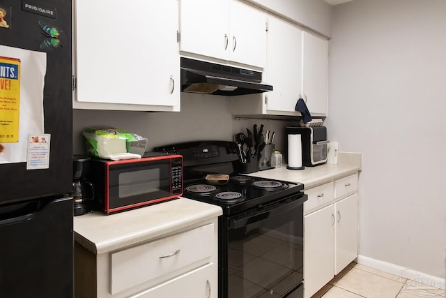 kitchen featuring fridge, black electric range oven, light countertops, and under cabinet range hood