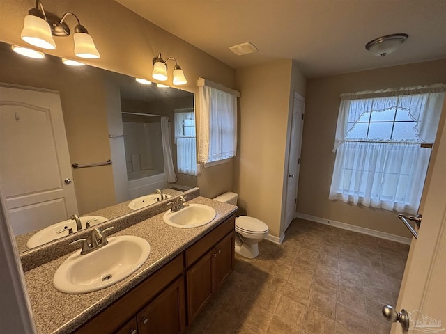 full bathroom with washtub / shower combination, vanity, a chandelier, and toilet