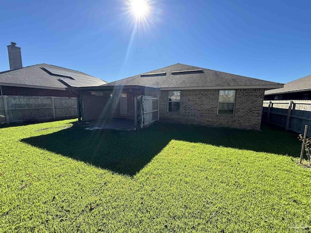 back of property featuring a lawn