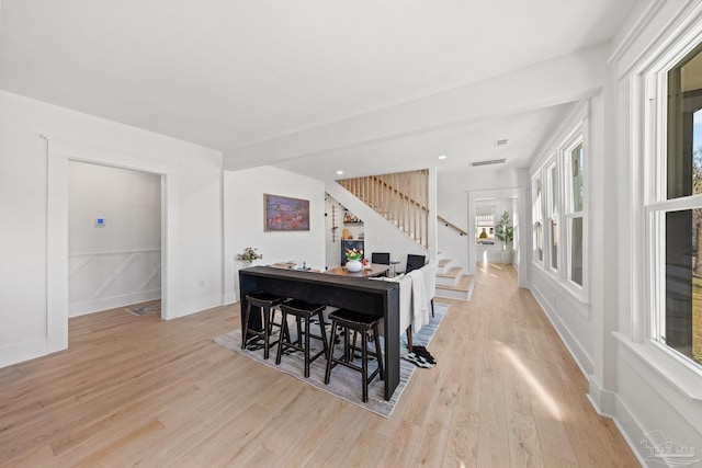 dining room with recessed lighting, stairway, baseboards, and light wood finished floors