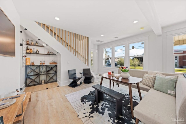 living room featuring stairway, recessed lighting, visible vents, and wood finished floors