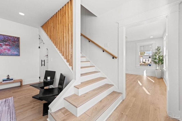 staircase featuring recessed lighting, baseboards, and wood finished floors