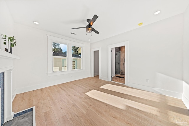 unfurnished living room featuring wood finished floors, recessed lighting, a fireplace, and visible vents