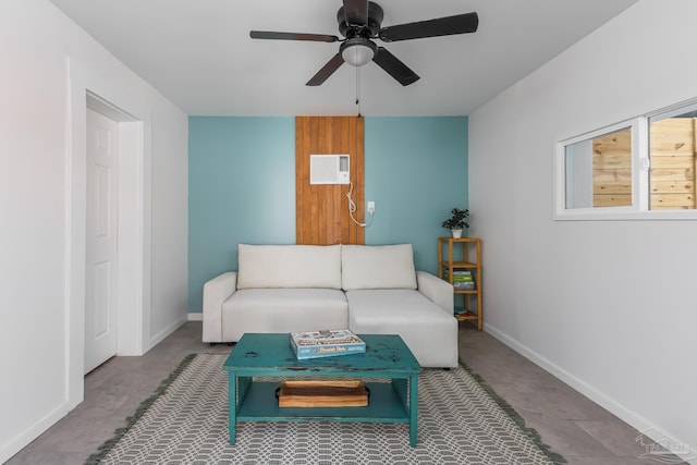 living room featuring a ceiling fan, baseboards, and a wall mounted AC