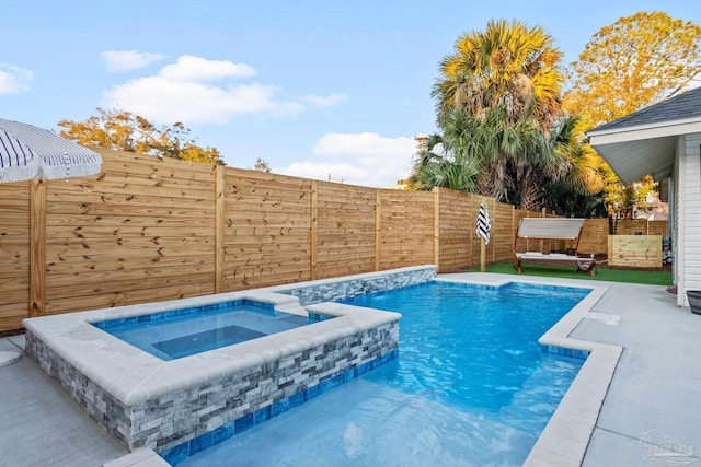 view of pool featuring a fenced in pool, an in ground hot tub, and a fenced backyard