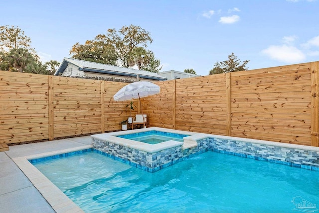 view of pool featuring fence and a pool with connected hot tub