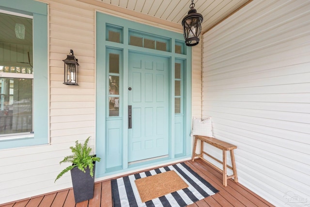 view of exterior entry featuring covered porch