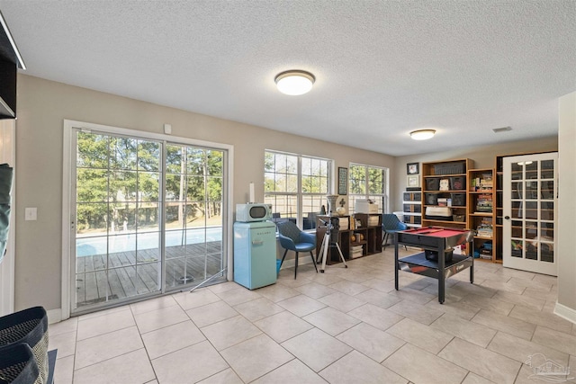 1064 Yellowstone Pass, Cantonment, FL 32533 - office area with a textured ceiling, light tile patterned floors, and baseboards