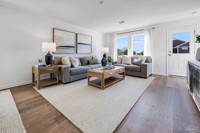 living room with wood finished floors and baseboards