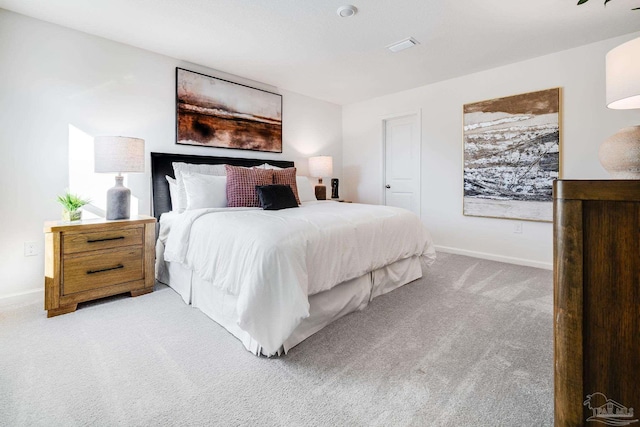 bedroom featuring light carpet and baseboards