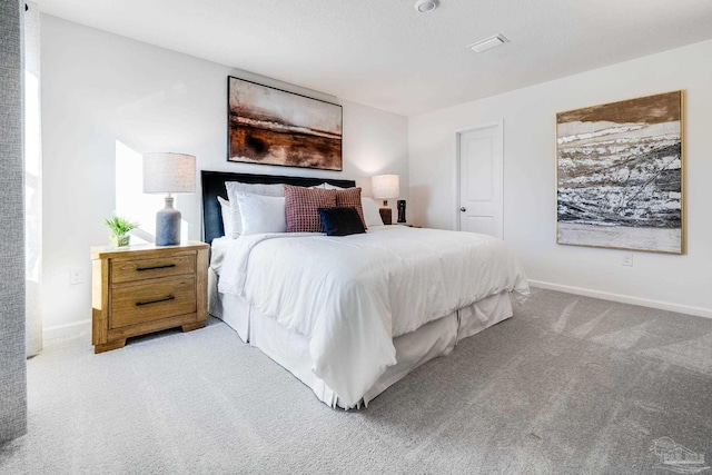 bedroom with carpet flooring and baseboards