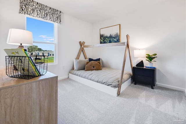 bedroom with carpet flooring and baseboards
