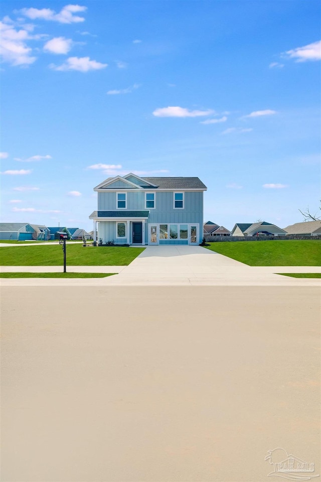 view of front of house featuring board and batten siding and a front lawn