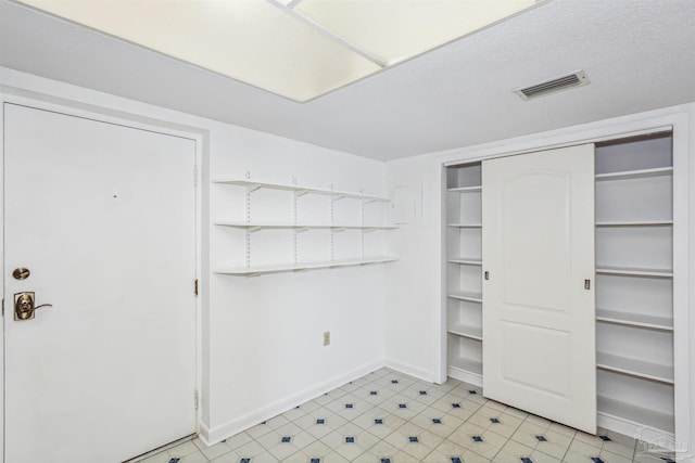 interior space with light floors and visible vents