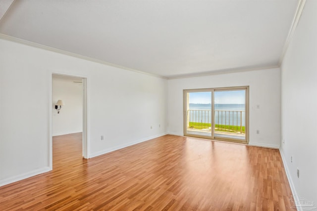 unfurnished room with a water view, ornamental molding, and light wood-type flooring