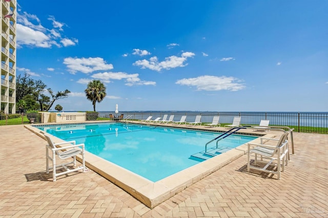 pool featuring a patio area and fence