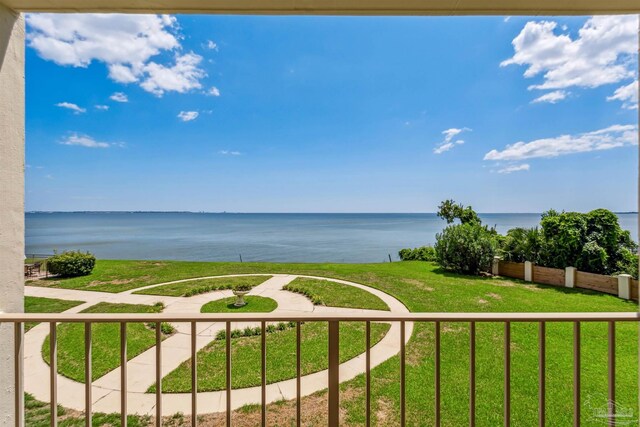 carpeted living room with beam ceiling and a water view