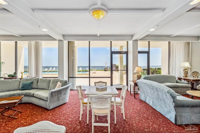 living room with carpet floors, floor to ceiling windows, and beamed ceiling