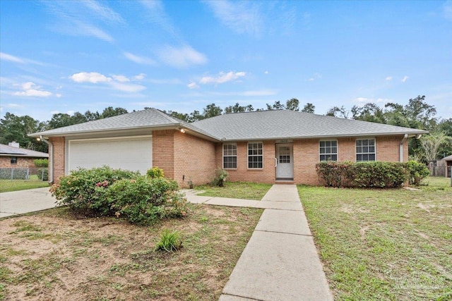 single story home featuring a garage and a front lawn