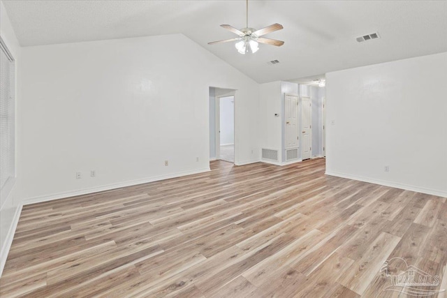 empty room featuring light wood-type flooring, vaulted ceiling, and ceiling fan