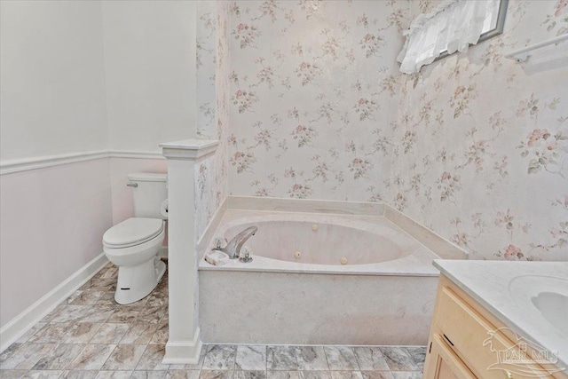 bathroom with a bathing tub, vanity, and toilet