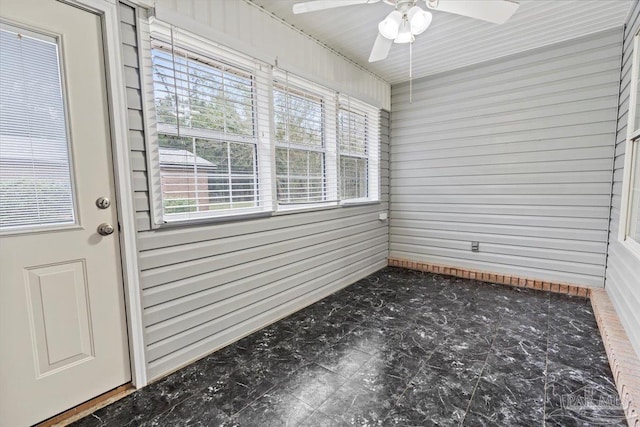 unfurnished sunroom with ceiling fan