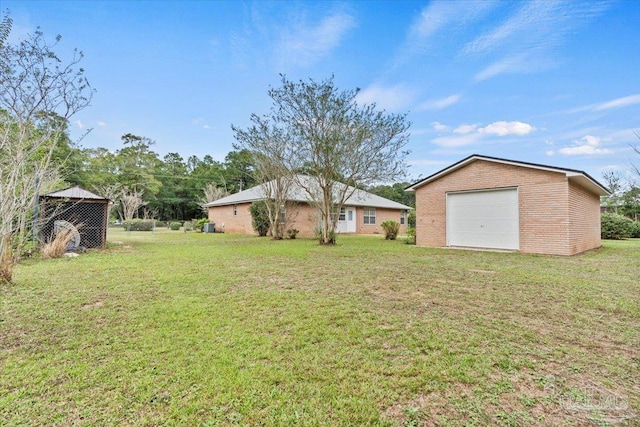 view of yard with a garage and an outdoor structure