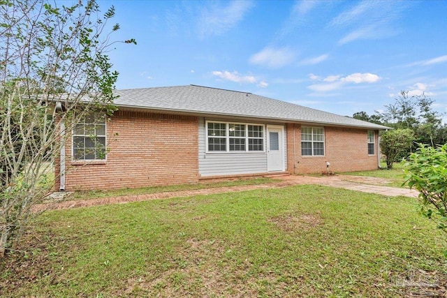 back of house featuring a yard