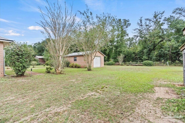 view of yard with an outbuilding and a garage