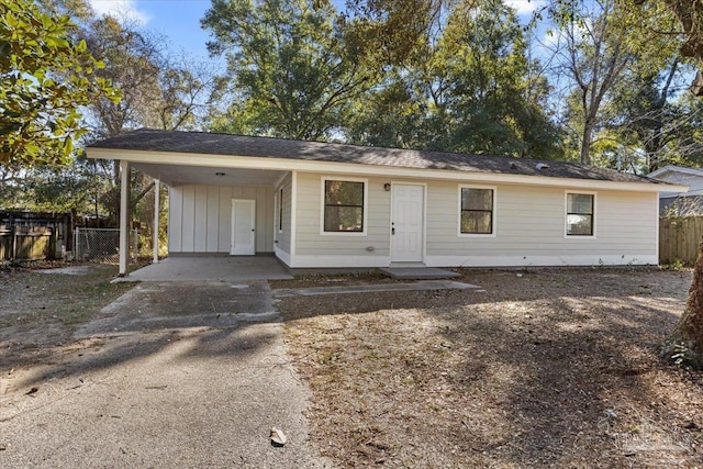 ranch-style home featuring a carport