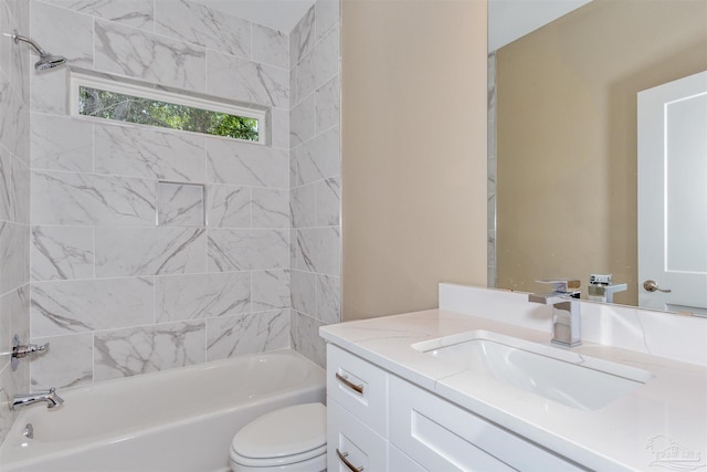 full bathroom featuring toilet, vanity, and tiled shower / bath