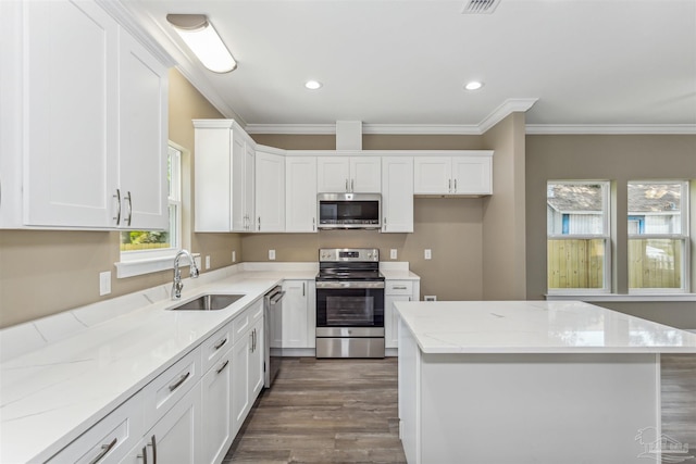 kitchen featuring stainless steel appliances, white cabinets, sink, dark hardwood / wood-style flooring, and ornamental molding