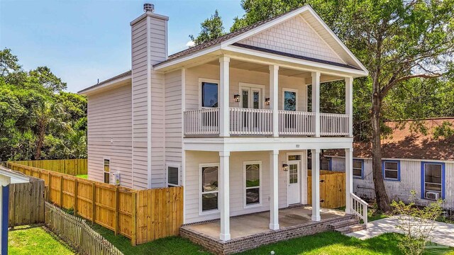 back of house with a balcony and a patio area