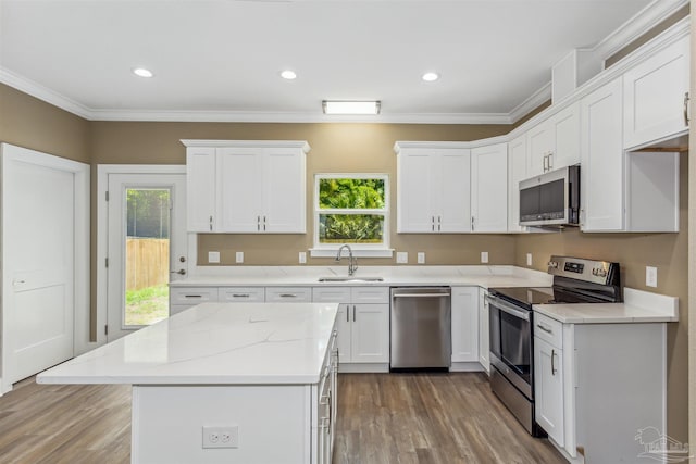 kitchen featuring plenty of natural light, sink, appliances with stainless steel finishes, and hardwood / wood-style floors