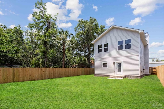 back of property featuring a yard