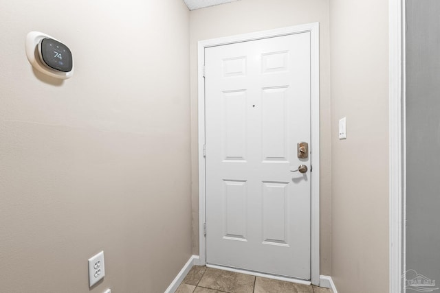 doorway with light tile patterned floors