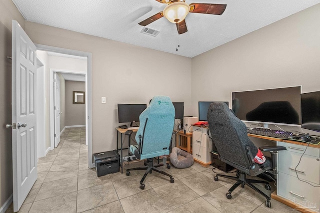 tiled home office featuring a textured ceiling and ceiling fan