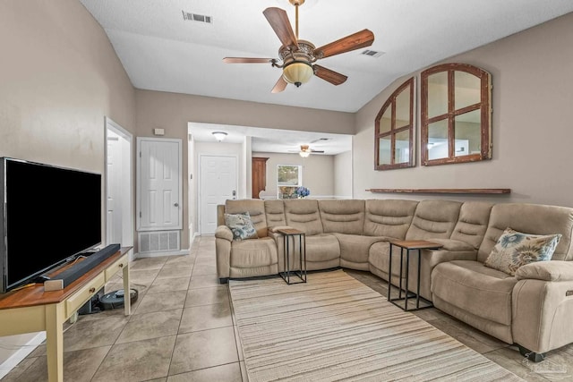 tiled living room with lofted ceiling and ceiling fan