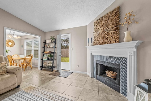 living room with lofted ceiling, a tile fireplace, a textured ceiling, and light tile patterned flooring