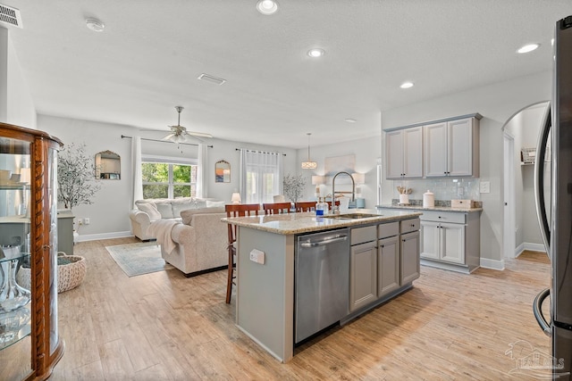 6347 Ladera Trl, Pace, FL 32571 - kitchen with appliances with stainless steel finishes, a sink, gray cabinets, open floor plan, and recessed lighting