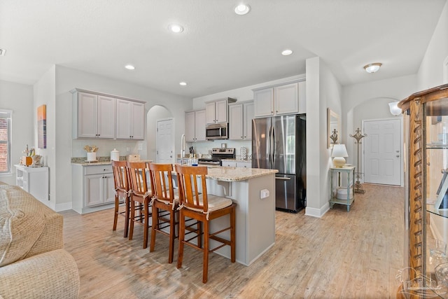 6347 Ladera Trl, Pace, FL 32571 - kitchen with stainless steel appliances, gray cabinetry, arched walkways, and recessed lighting