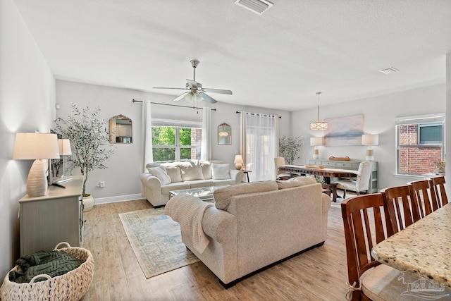 6347 Ladera Trl, Pace, FL 32571 - living room featuring a ceiling fan, light wood finished floors, and baseboards