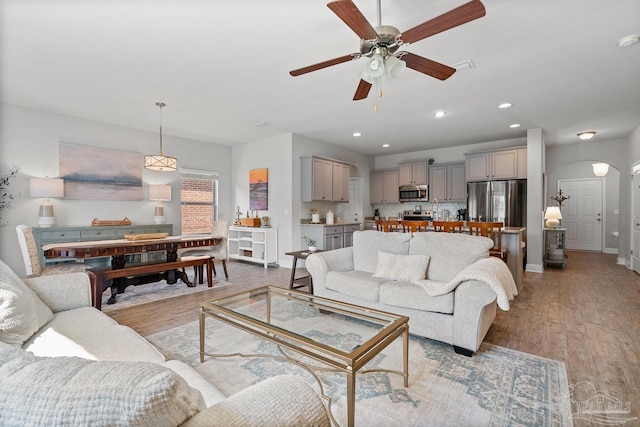 6347 Ladera Trl, Pace, FL 32571 - living area with a ceiling fan, arched walkways, light wood finished floors, recessed lighting, and baseboards