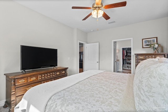 6347 Ladera Trl, Pace, FL 32571 - bedroom with a walk in closet, a ceiling fan, and a closet